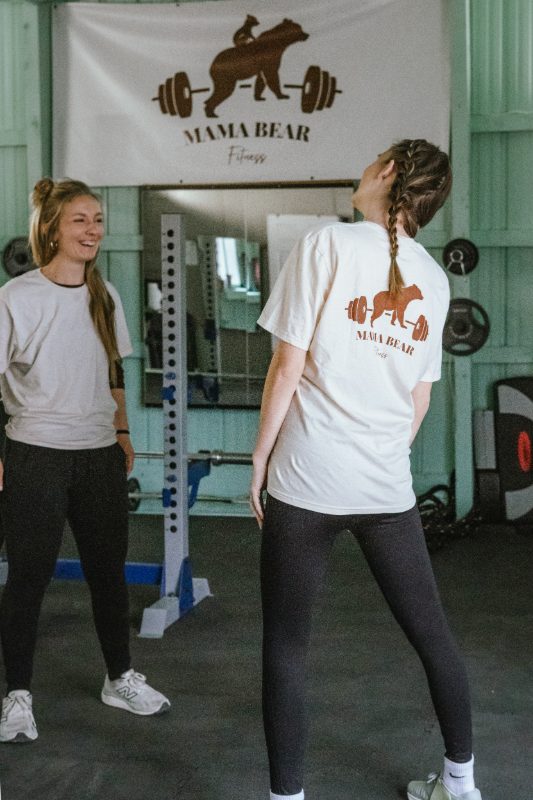 Mama Bear Fitness logo on the back of a client's shirt